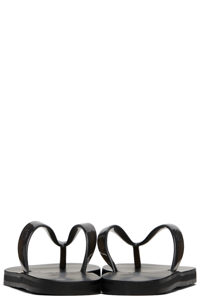 Handcrafted vinyl flip-flops.

· Logo-embossed thong-style strap
· Vegetable-tanned buffed leather footbed
· Hand-stitched stacked leather midsole
· Logo-embossed rubber sole

Supplier color: Black