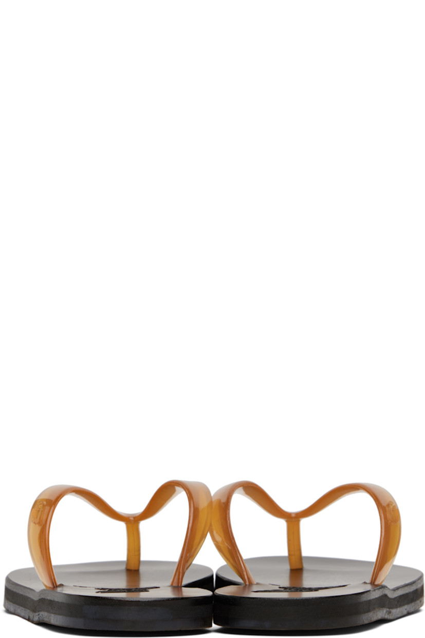 Handcrafted semi-transparent vinyl flip-flops.

· Logo-embossed thong-style strap
· Vegetable-tanned buffed leather footbed
· Hand-stitched stacked leather midsole
· Logo-embossed rubber sole

Supplier color: Clear caramel