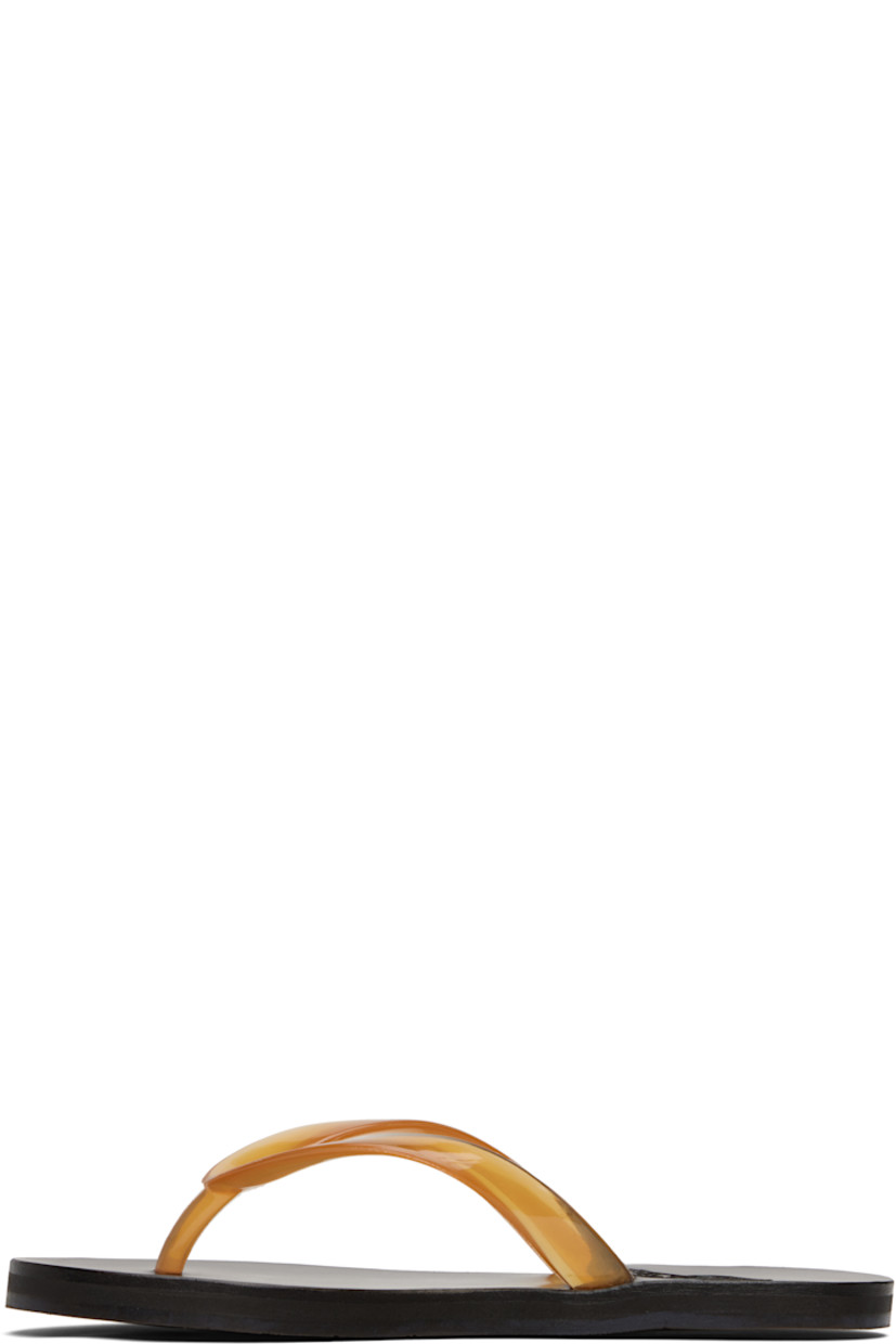 Handcrafted semi-transparent vinyl flip-flops.

· Logo-embossed thong-style strap
· Vegetable-tanned buffed leather footbed
· Hand-stitched stacked leather midsole
· Logo-embossed rubber sole

Supplier color: Clear caramel