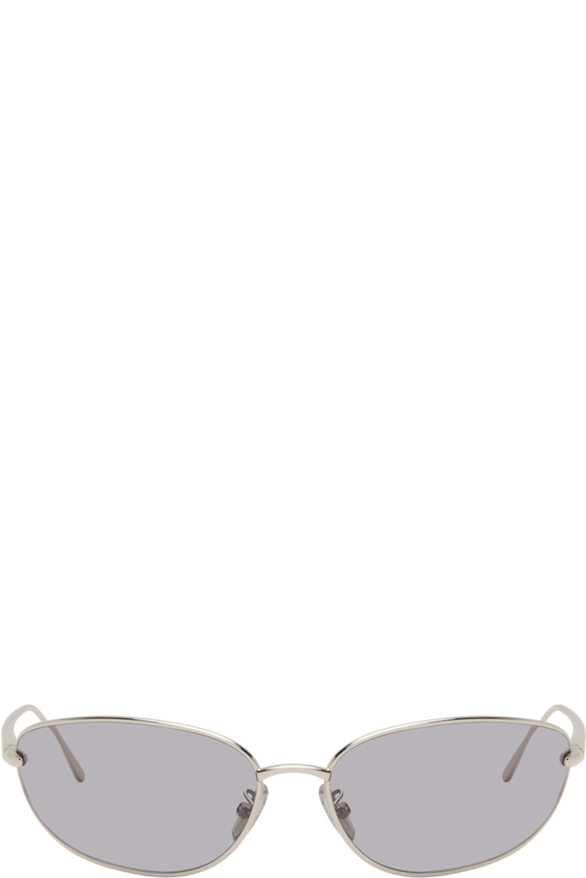 Wraparound oval metal-frame sunglasses.

· Gray lenses 
· Adjustable rubber nose pads
· Logo engraved at temples
· Includes pouch
· Size: 68.15 120

Supplier color: Shiny palladium