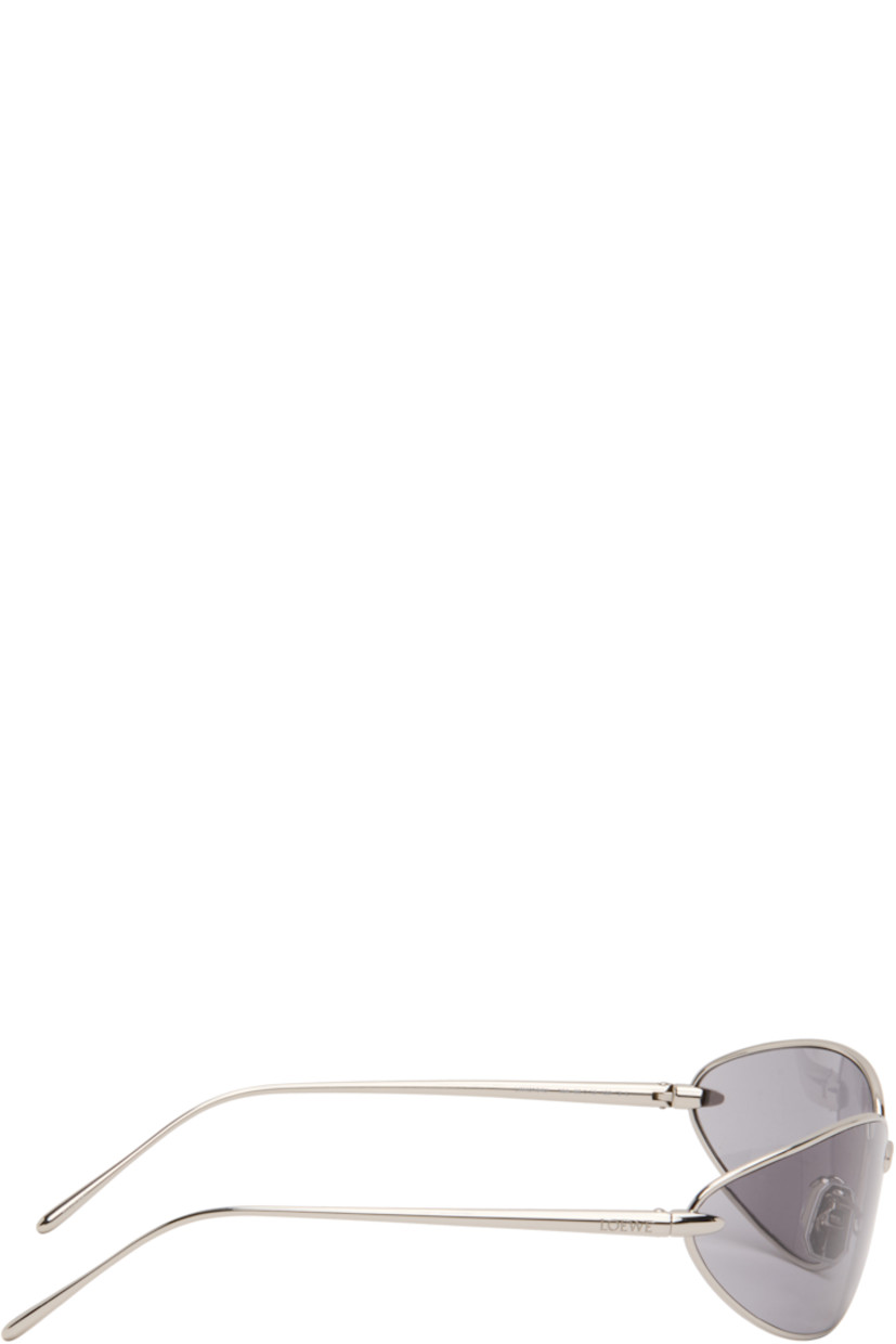 Wraparound oval metal-frame sunglasses.

· Gray lenses 
· Adjustable rubber nose pads
· Logo engraved at temples
· Includes pouch
· Size: 68.15 120

Supplier color: Shiny palladium