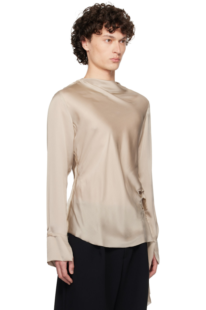 Semi-sheer silk satin blouse. Frayed edges throughout. 

· Draped boatneck 
· Extended draped panel at side seam 
· Vent at cuffs

Supplier color: Taupe