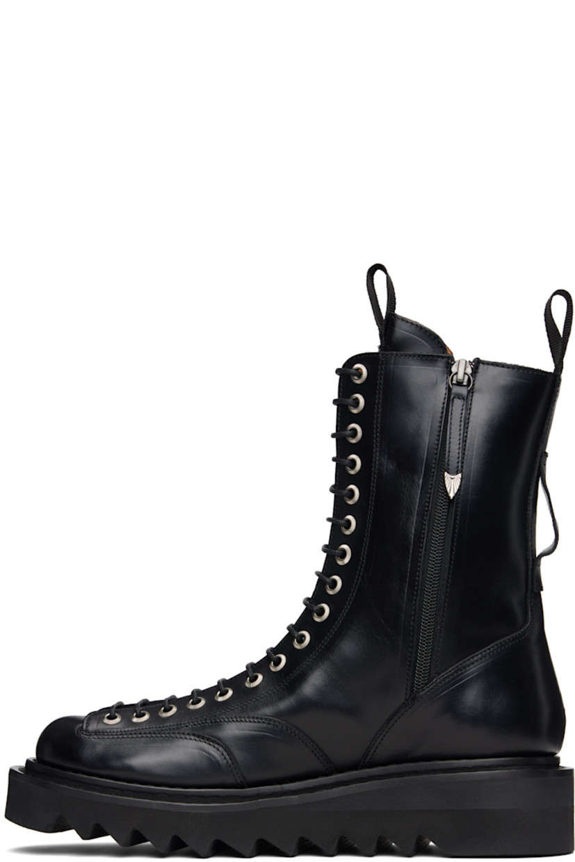 Mid-calf buffed leather boots.

· Lace-up closure
· Pull-loop at tongue and heel collar
· Zip closure at sides
· Foam rubber midsole 
· Treaded rubber sole

Supplier color: Black