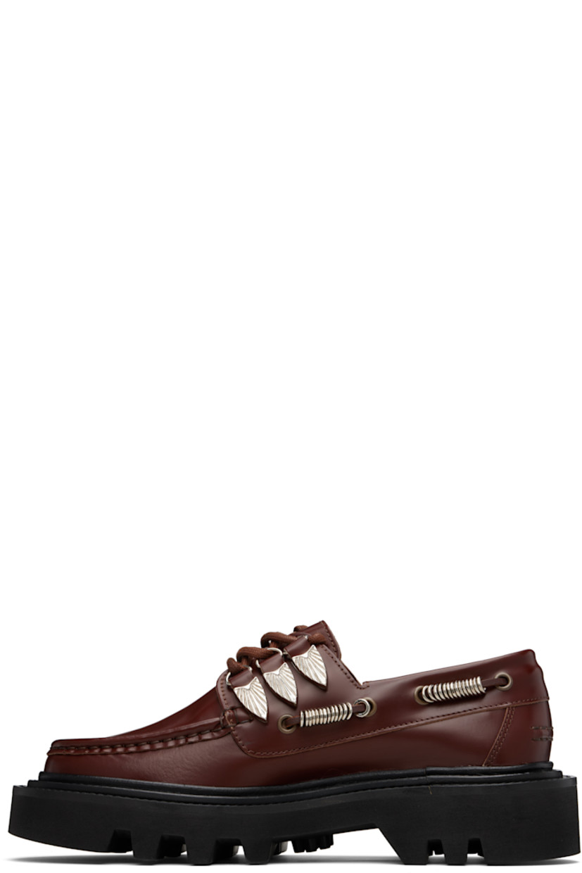Polished leather derbys.

· Boat-shoe-style upper
· Moc toe
· Lace-up closure with engraved hardware
· Leather lacing at sides with hoop charms
· Leather lining
· Foam rubber platform sole
· Platform: H2"

Supplier color: Brown