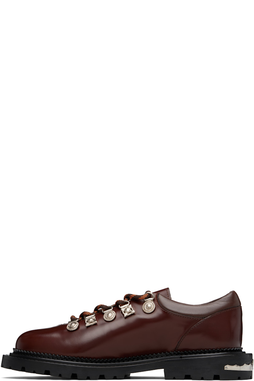 Polished leather derbys.

· Lace-up closure with engraved charms
· Padded leather collar
· Serrated edge at welt
· Etched plaque at heel 
· Treaded rubber sole

Supplier color: Brown