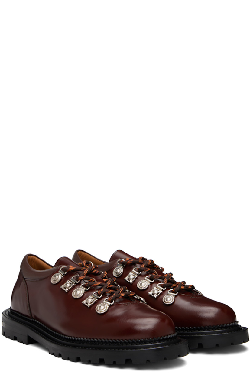 Polished leather derbys.

· Lace-up closure with engraved charms
· Padded leather collar
· Serrated edge at welt
· Etched plaque at heel 
· Treaded rubber sole

Supplier color: Brown