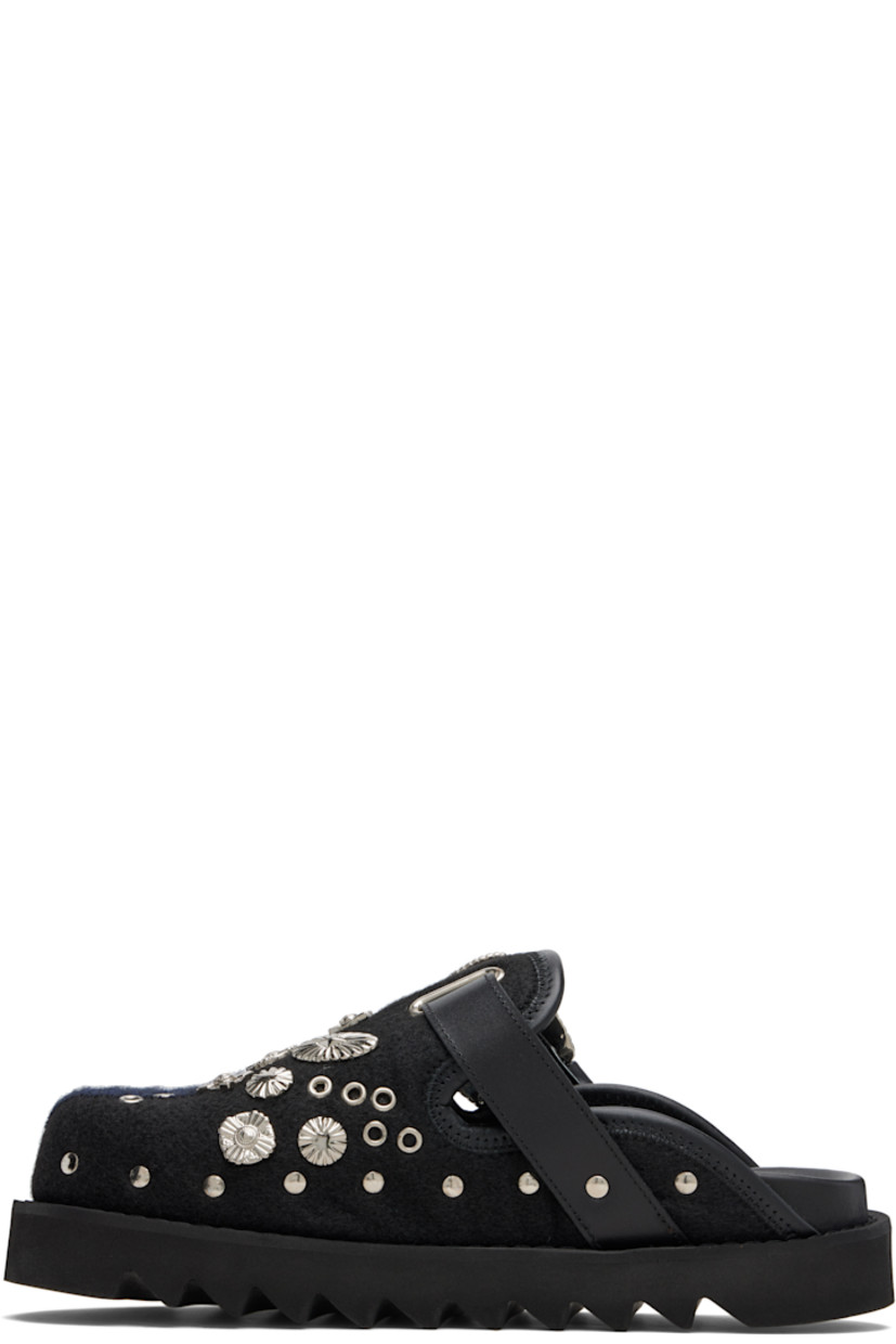 Melton slip-on loafers.

· Studs at toe and sides
· Graphic hardware and metal eyelets at vamp
· Pin-buckle strap at vamp
· Mesh lining
· Foam rubber midsole
· Treaded rubber sole

Available exclusively at SSENSE.

Supplier color: Black/Navy