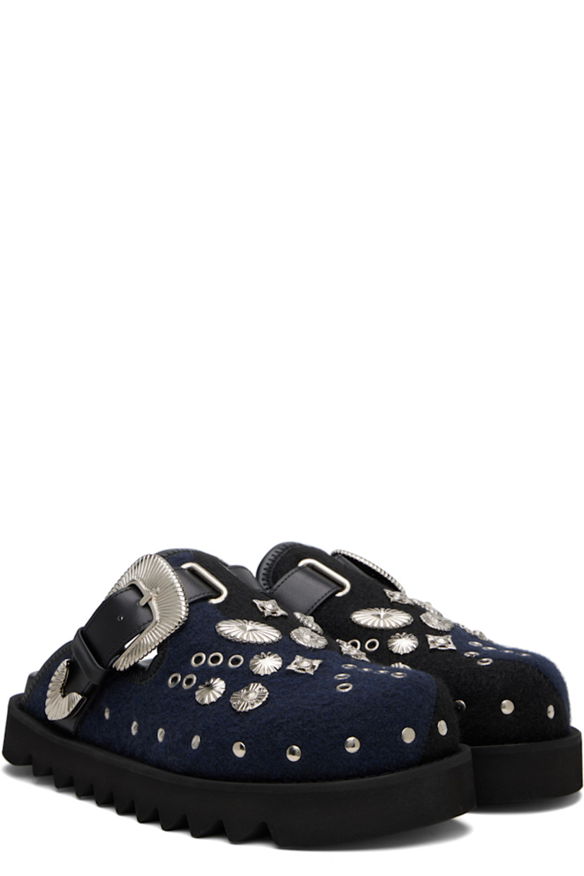 Melton slip-on loafers.

· Studs at toe and sides
· Graphic hardware and metal eyelets at vamp
· Pin-buckle strap at vamp
· Mesh lining
· Foam rubber midsole
· Treaded rubber sole

Available exclusively at SSENSE.

Supplier color: Black/Navy