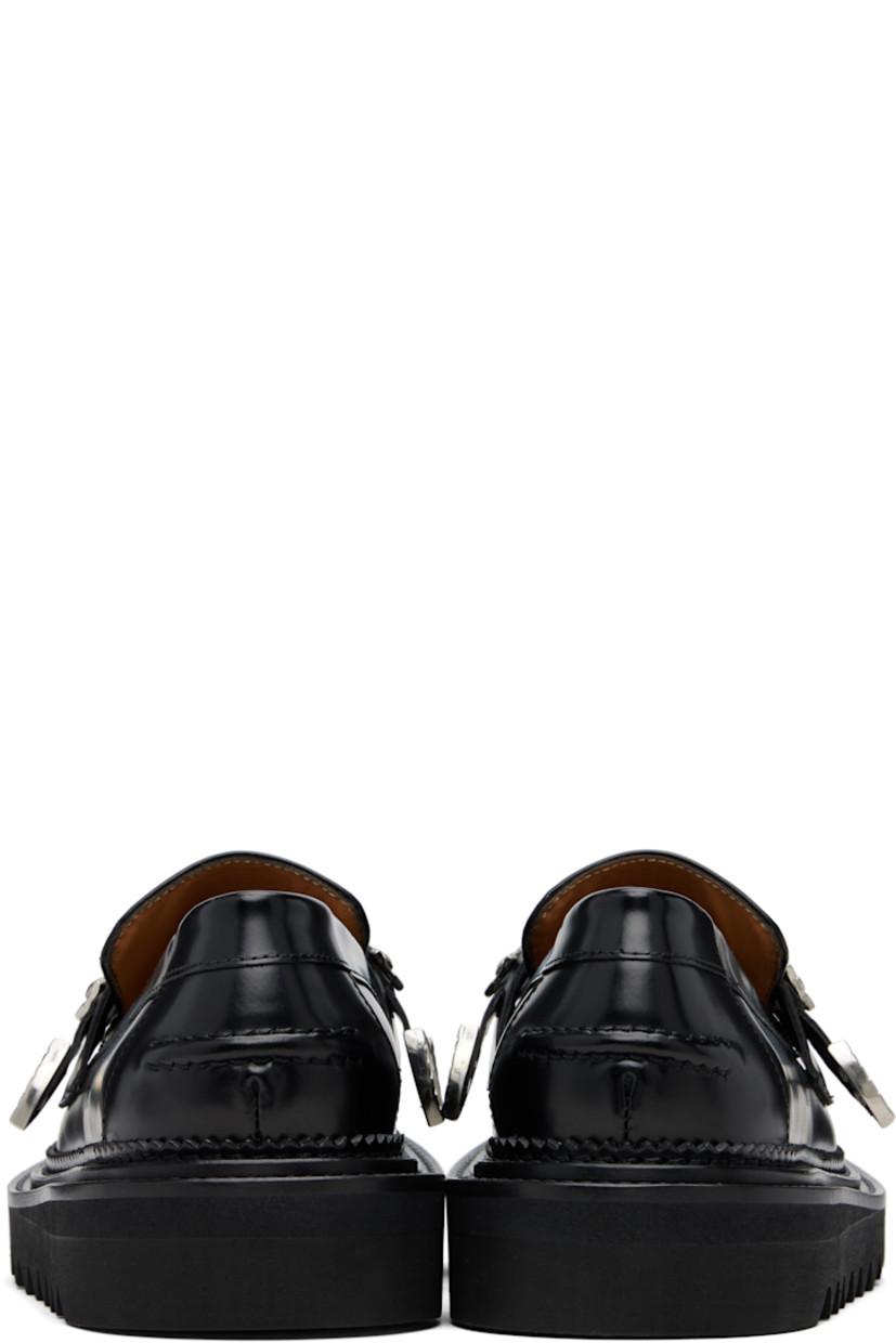 Buffed leather loafers.

· Moc toe
· Strap with graphic hardware at vamp
· Serrated detailing at welt
· Pinched seam at heel counter
· Foam rubber midsole
· Treaded rubber sole

Supplier color: Black