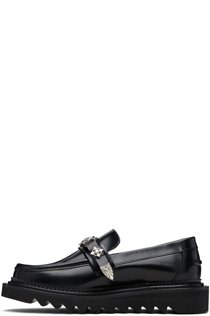 Buffed leather loafers.

· Moc toe
· Strap with graphic hardware at vamp
· Serrated detailing at welt
· Pinched seam at heel counter
· Foam rubber midsole
· Treaded rubber sole

Supplier color: Black