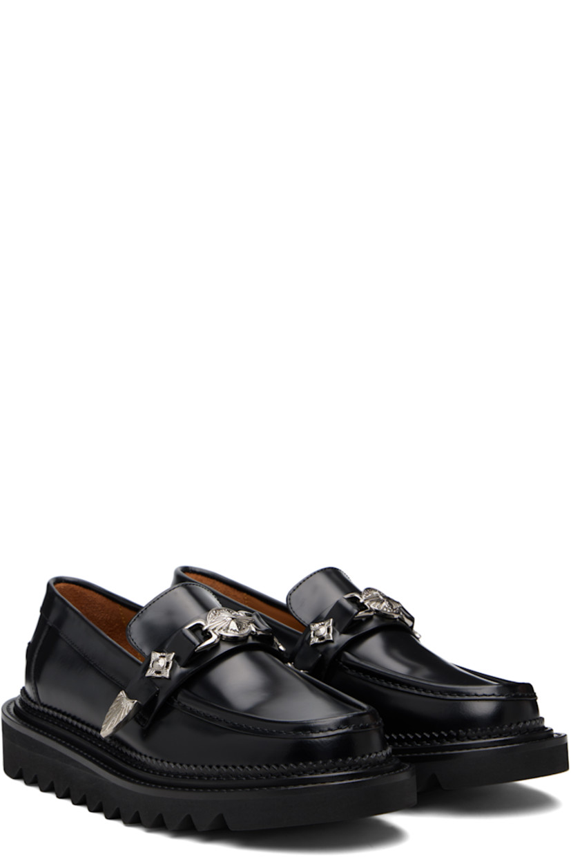 Buffed leather loafers.

· Moc toe
· Strap with graphic hardware at vamp
· Serrated detailing at welt
· Pinched seam at heel counter
· Foam rubber midsole
· Treaded rubber sole

Supplier color: Black