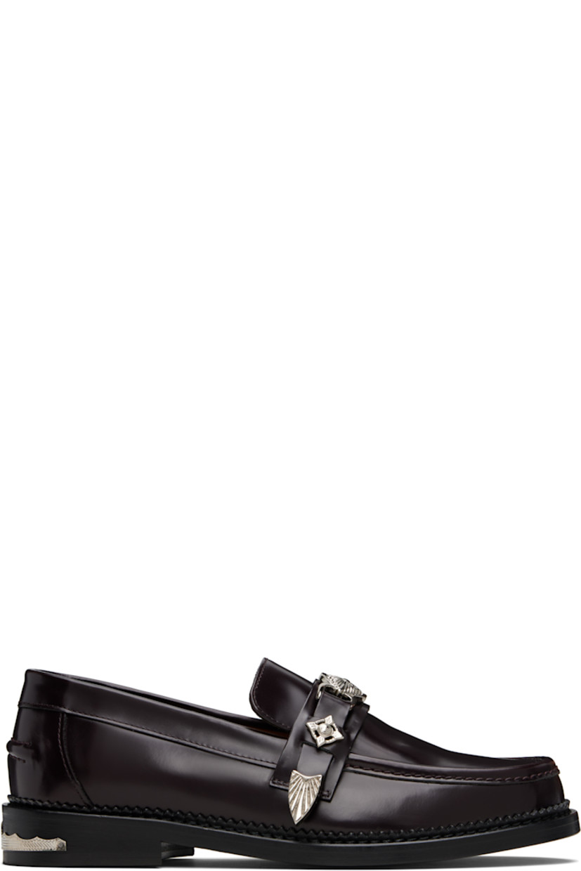 Polished leather loafers.

· Moc toe
· Strap with graphic hardware at vamp
· Pinched seam at heel counter
· Serrated edge at welt
· Buffed leather lining
· Engraved plaque at heel
· Stacked leather heel with rubber injection
· Leather sole

Available exclusively at SSENSE.

Supplier color: Burgundy
