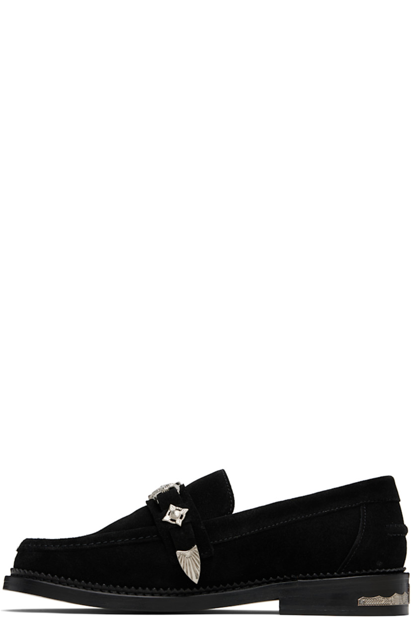 Suede loafers.

· Moc toe
· Strap with graphic hardware at vamp
· Pinched seam at heel counter
· Serrated edge at welt
· Buffed leather lining
· Engraved plaque at heel
· Stacked leather heel with rubber injection
· Leather sole

Available exclusively at SSENSE.

Supplier color: Black suede