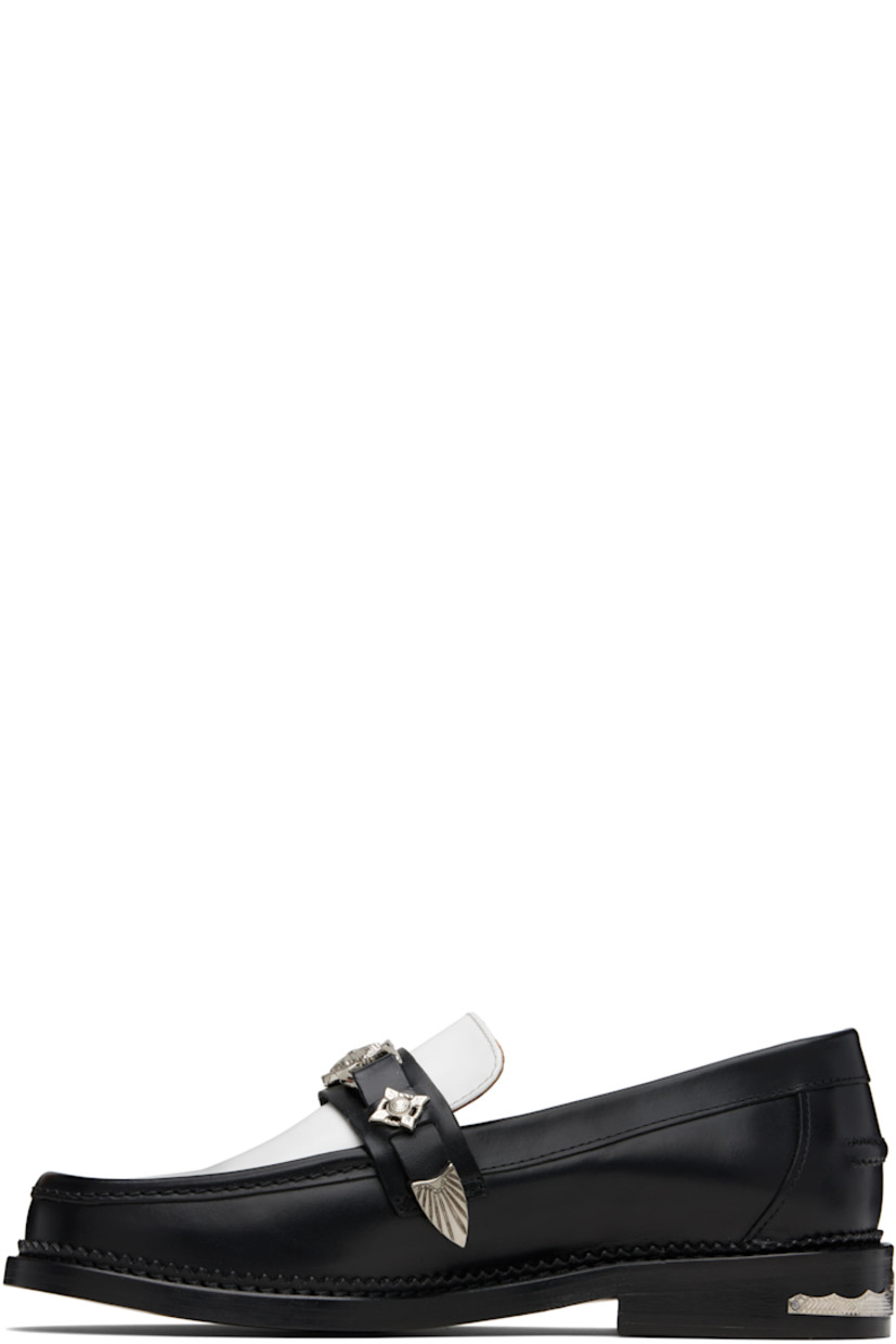 Polished leather loafers.

· Moc toe
· Strap with graphic hardware at vamp
· Pinched seam at heel counter
· Serrated edge at welt
· Buffed leather lining
· Engraved plaque at heel
· Stacked leather heel with rubber injection
· Leather sole

Available exclusively at SSENSE.

Supplier color: Black/White