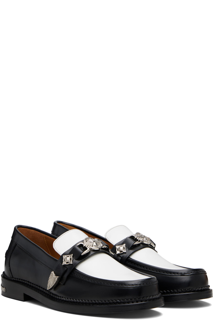 Polished leather loafers.

· Moc toe
· Strap with graphic hardware at vamp
· Pinched seam at heel counter
· Serrated edge at welt
· Buffed leather lining
· Engraved plaque at heel
· Stacked leather heel with rubber injection
· Leather sole

Available exclusively at SSENSE.

Supplier color: Black/White