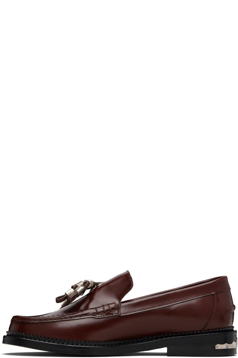 Buffed leather loafers.

· Moc toe
· Knotted strap with O-rings at vamp
· Pinched seam at heel counter
· Serrated edge at welt
· Engraved plaque at heel
· Stacked leather heel with rubber injection
· Leather sole

Supplier color: Brown