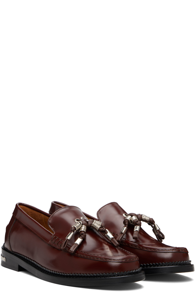 Buffed leather loafers.

· Moc toe
· Knotted strap with O-rings at vamp
· Pinched seam at heel counter
· Serrated edge at welt
· Engraved plaque at heel
· Stacked leather heel with rubber injection
· Leather sole

Supplier color: Brown