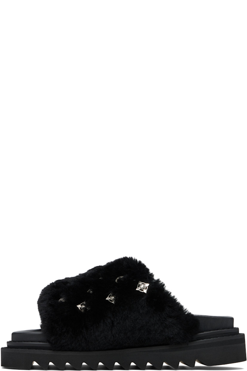 Shearling slip-on sandals.

· Graphic hardware throughout
· Open toe
· Logo stamp at molded footbed
· Buffed leather lining
· Foam rubber midsole
· Treaded rubber sole

Supplier color: Black
