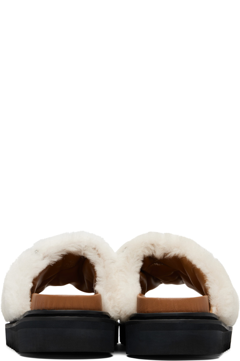 Shearling slip-on sandals.

· Graphic hardware throughout
· Open toe
· Logo stamp at molded footbed
· Buffed leather lining
· Foam rubber midsole
· Treaded rubber sole

Supplier color: Beige