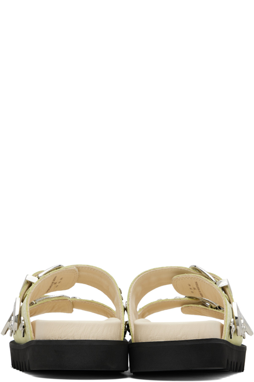 Suede sandals.

· Graphic hardware throughout
· Open toe
· Pin-buckle straps at vamp
· Logo stamp at molded footbed
· Buffed leather lining
· Foam rubber midsole
· Treaded rubber sole
· Contrast stitching in white

Supplier color: Beige