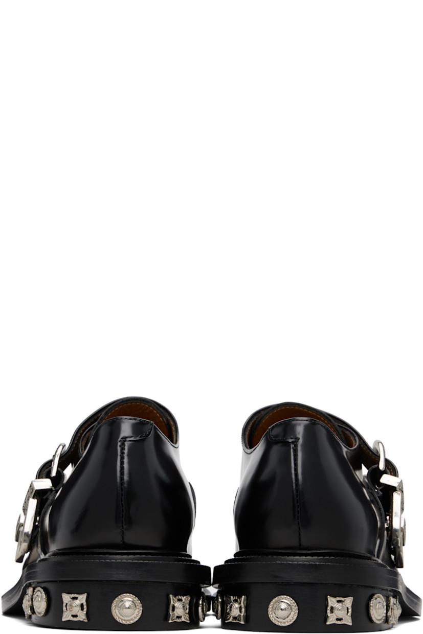 Polished leather monkstraps.

· Strap with pin-buckle fastenings at vamp
· Buffed leather lining
· Serrated detailing at welt
· Graphic hardware at heel
· Stacked leather heel with rubber injection
· Leather sole

Supplier color: Black