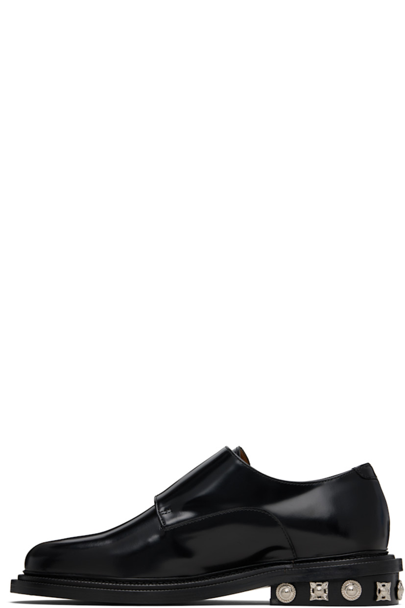 Polished leather monkstraps.

· Strap with pin-buckle fastenings at vamp
· Buffed leather lining
· Serrated detailing at welt
· Graphic hardware at heel
· Stacked leather heel with rubber injection
· Leather sole

Supplier color: Black