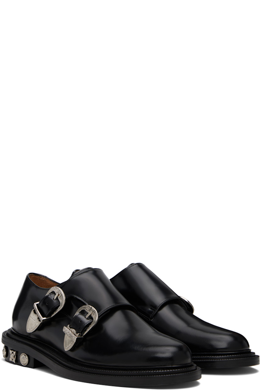 Polished leather monkstraps.

· Strap with pin-buckle fastenings at vamp
· Buffed leather lining
· Serrated detailing at welt
· Graphic hardware at heel
· Stacked leather heel with rubber injection
· Leather sole

Supplier color: Black