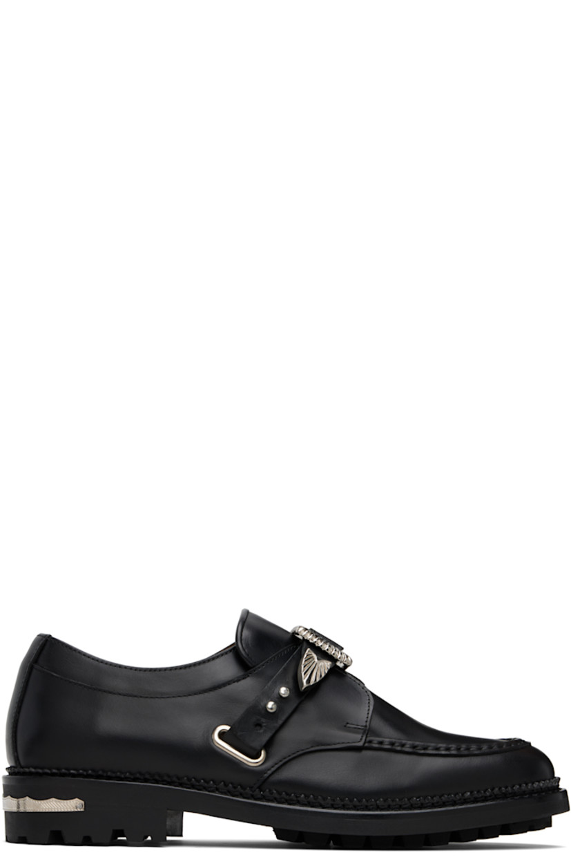 Polished leather monkstraps.

· Moc toe
· Post-stud strap at vamp
· Serrated detailing at welt
· Engraved plaque at heel
· Treaded rubber sole

Available exclusively at SSENSE.

Supplier color: Black