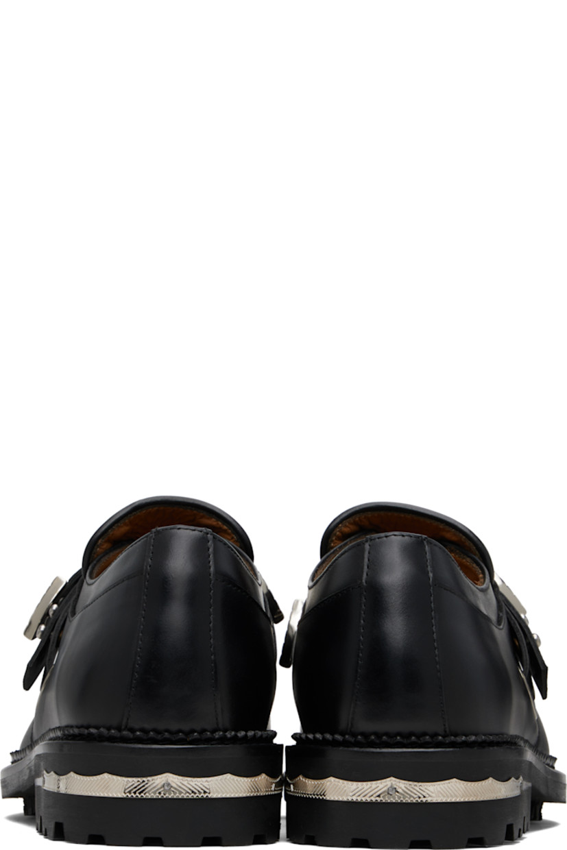 Polished leather monkstraps.

· Moc toe
· Post-stud strap at vamp
· Serrated detailing at welt
· Engraved plaque at heel
· Treaded rubber sole

Available exclusively at SSENSE.

Supplier color: Black
