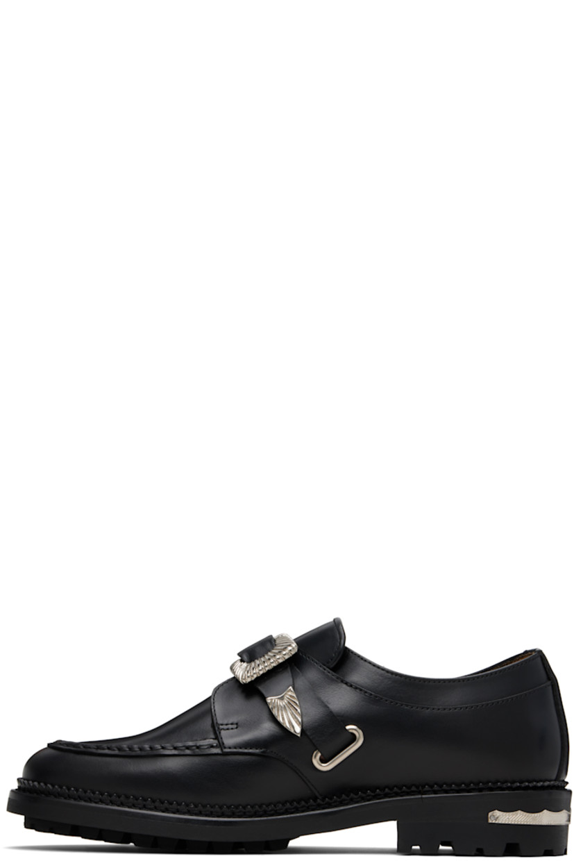 Polished leather monkstraps.

· Moc toe
· Post-stud strap at vamp
· Serrated detailing at welt
· Engraved plaque at heel
· Treaded rubber sole

Available exclusively at SSENSE.

Supplier color: Black