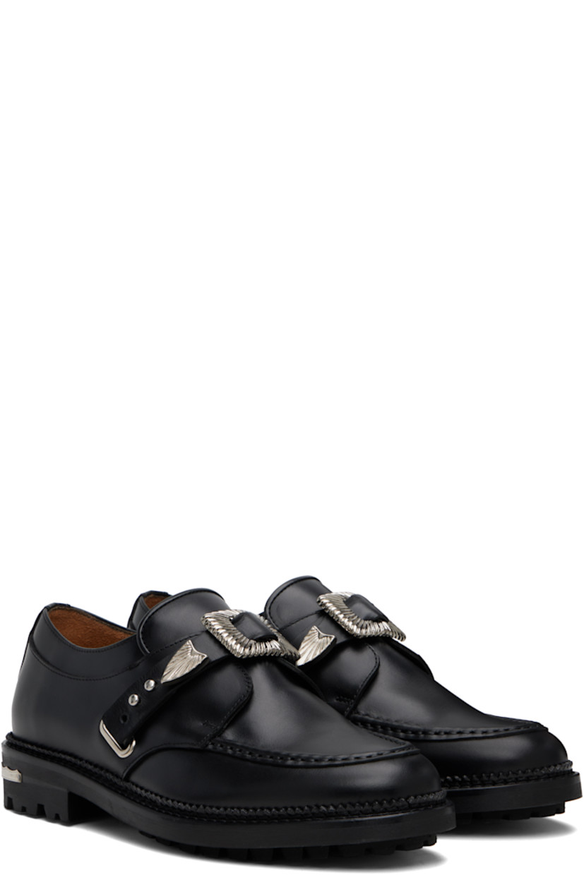 Polished leather monkstraps.

· Moc toe
· Post-stud strap at vamp
· Serrated detailing at welt
· Engraved plaque at heel
· Treaded rubber sole

Available exclusively at SSENSE.

Supplier color: Black
