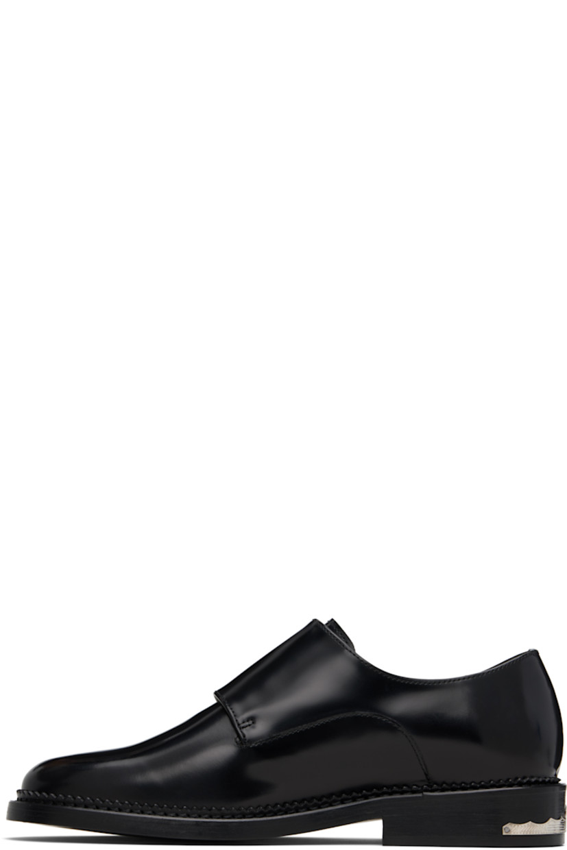 Polished leather monkstraps.

· Strap with pin-buckle fastenings at vamp
· Buffed leather lining
· Serrated detailing at welt
· Engraved plaque at heel
· Stacked leather heel with rubber injection
· Leather sole

Supplier color: Black