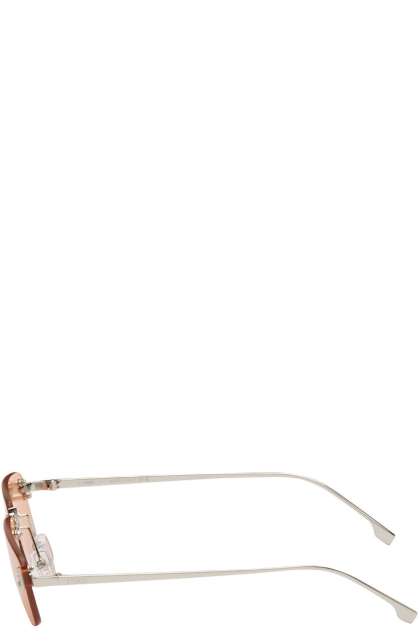 Rectangular rimless metal-frame sunglasses.

· Orange lenses 
· 100% UVA/UVB protection, category 2
· Adjustable rubber nose pads
· Crystal-cut logo at face
· Logo engraved at temples
· Includes pouch
· Size: 54.16 135 

Supplier color: Shiny palladium/