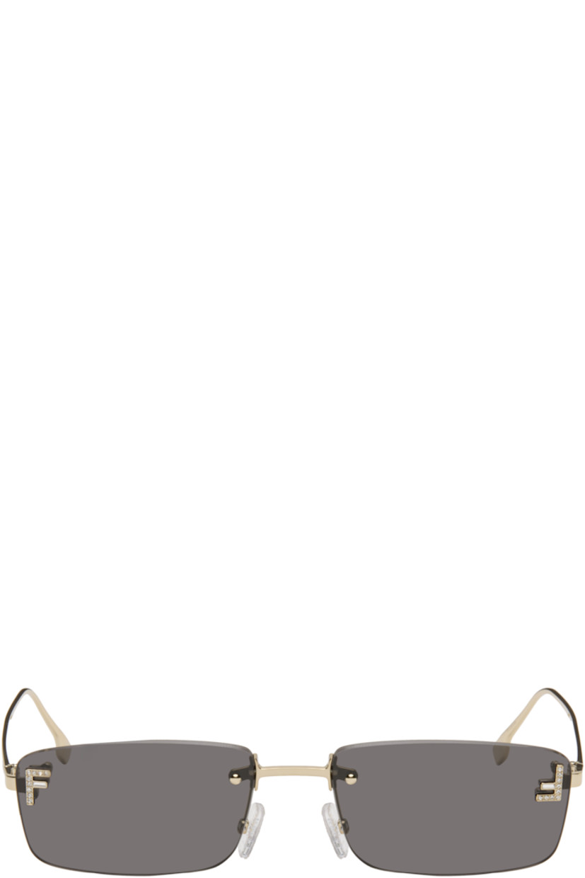Rectangular rimless metal-frame sunglasses.

· Gray lenses 
· 100% UVA/UVB protection, category 3 
· Adjustable rubber nose pads
· Crystal-cut logo at face
· Logo engraved at temples
· Includes pouch
· Size: 54.16 135 

Supplier color: Gold/Smoke