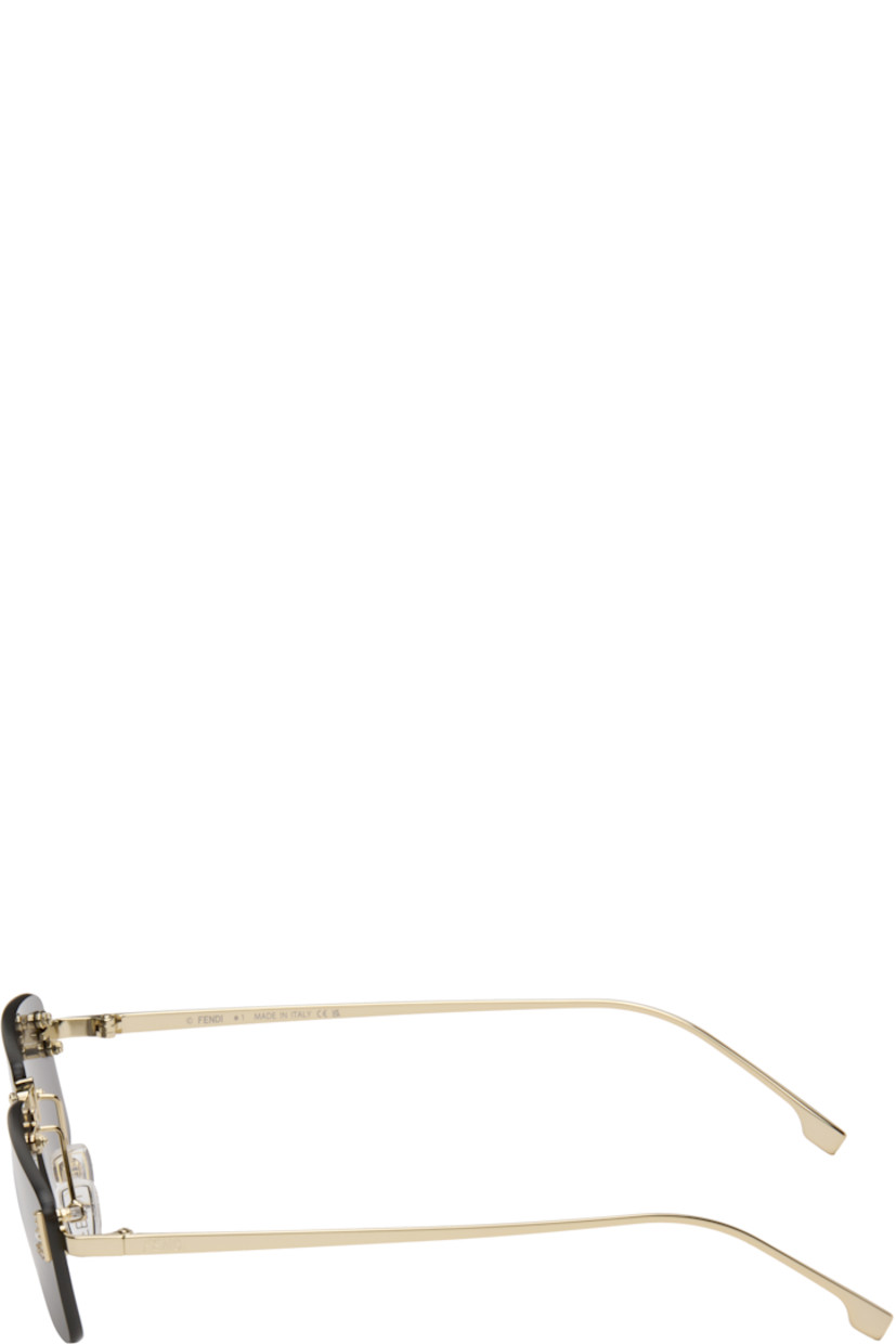 Rectangular rimless metal-frame sunglasses.

· Gray lenses 
· 100% UVA/UVB protection, category 3 
· Adjustable rubber nose pads
· Crystal-cut logo at face
· Logo engraved at temples
· Includes pouch
· Size: 54.16 135 

Supplier color: Gold/Smoke