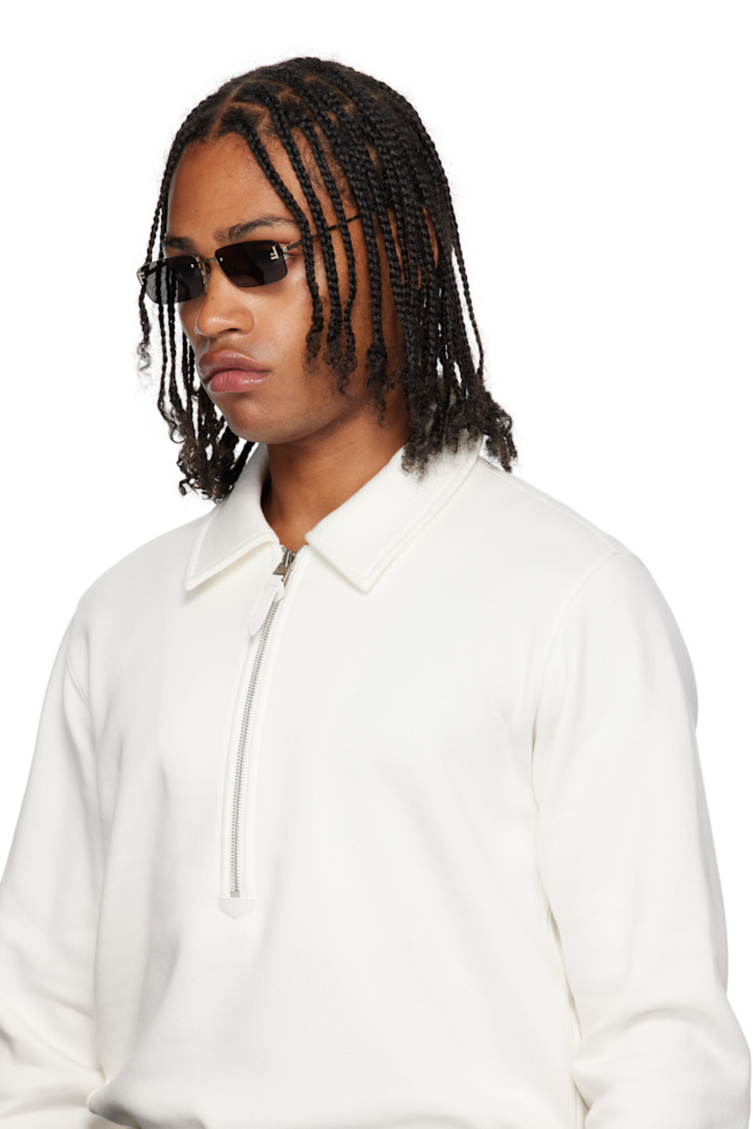 Rectangular rimless metal-frame sunglasses.

· Gray lenses 
· 100% UVA/UVB protection, category 3 
· Adjustable rubber nose pads
· Crystal-cut logo at face
· Logo engraved at temples
· Includes pouch
· Size: 54.16 135 

Supplier color: Gold/Smoke