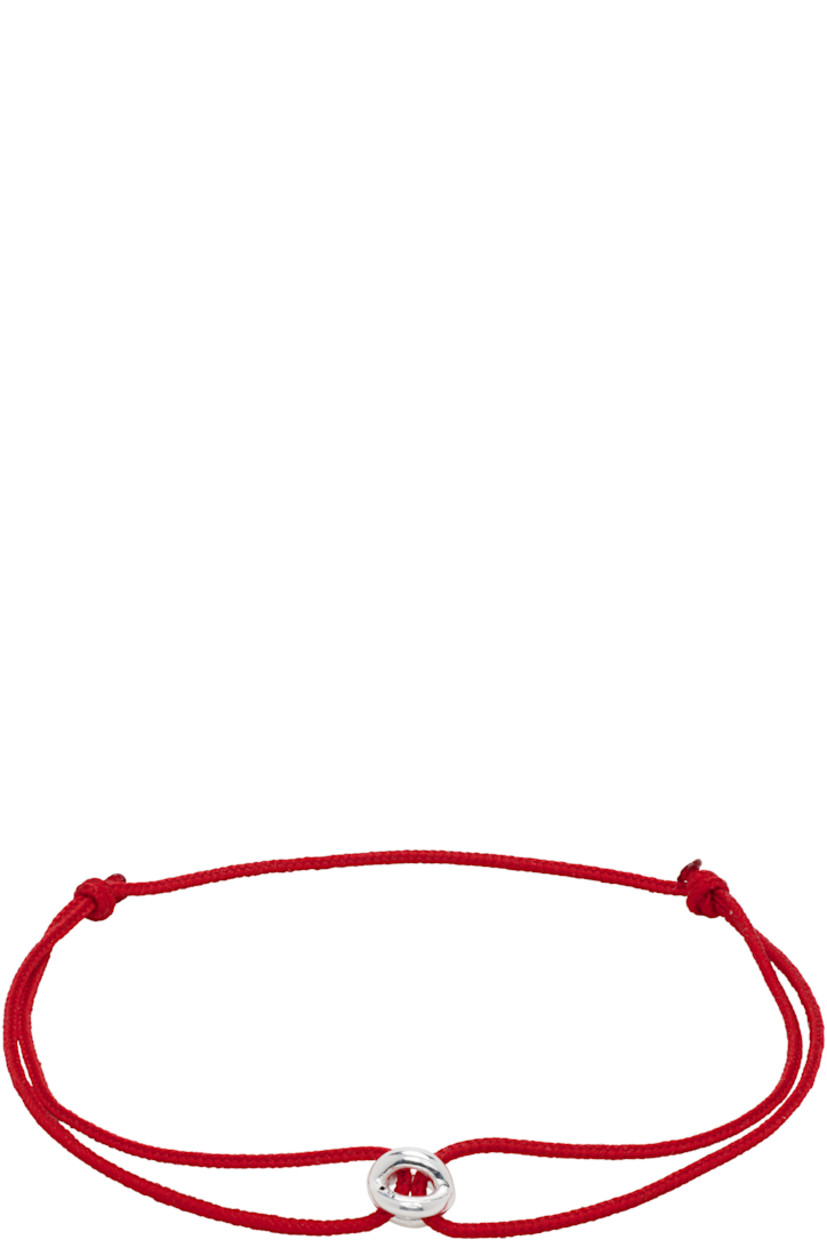 Cord bracelet in red.

· Recycled sterling silver charm at face 
· Logo and hallmarking at charm 
· Pull-through fastening 
· Approx. full diameter: D6"

Supplier color: Red