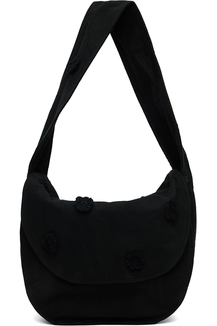 Cotton drill messenger bag.

· Crocheted floral appliqués throughout
· Fixed crossbody strap
· Foldover flap
· Patch pocket at interior
· H14" x W17" x D7.5"

Supplier color: Black