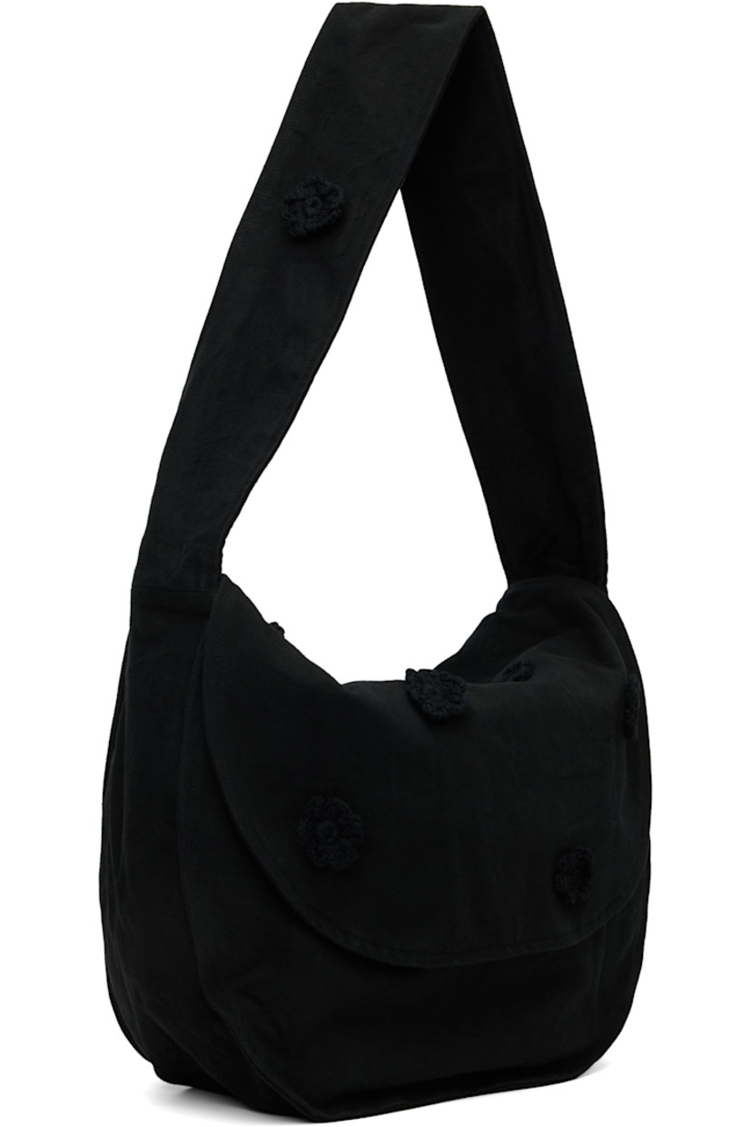 Cotton drill messenger bag.

· Crocheted floral appliqués throughout
· Fixed crossbody strap
· Foldover flap
· Patch pocket at interior
· H14" x W17" x D7.5"

Supplier color: Black