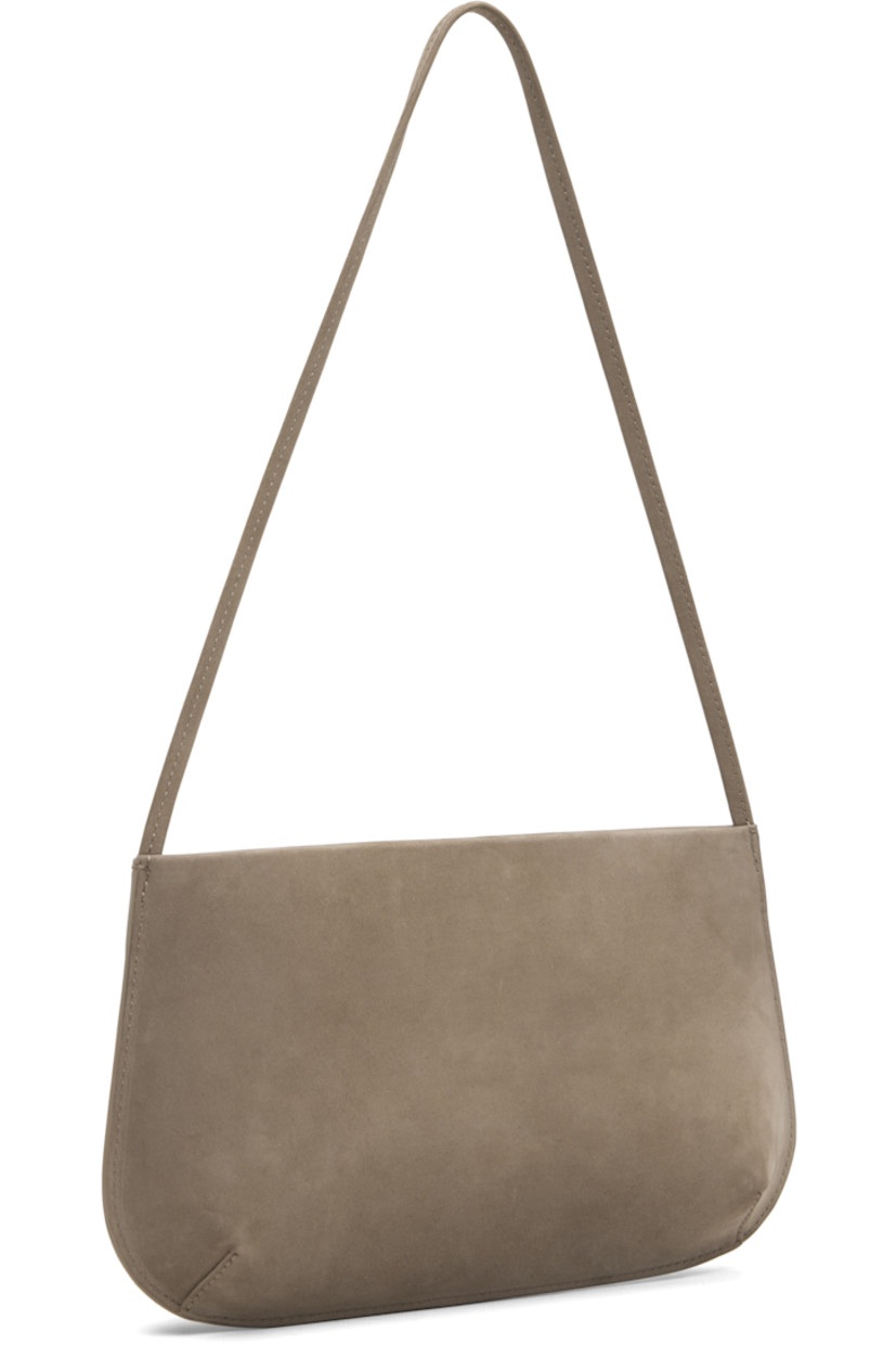 Nubuck shoulder bag.

· Fixed shoulder strap
· Darts at base
· Magnetic closure
· Patch pocket at interior
· Twill lining
· H6" x W11" x D2.25"

Supplier color: Biche nubuck