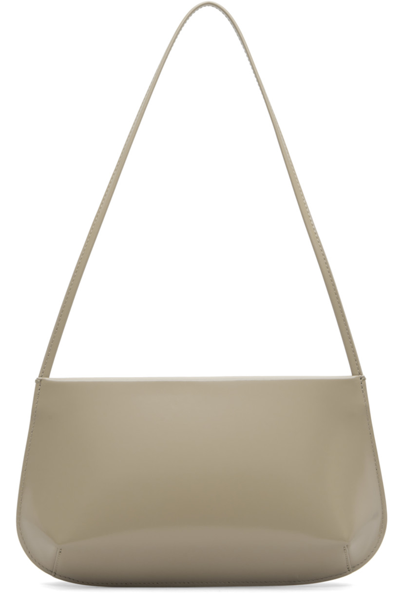 Spazzolato calfskin shoulder bag.

· Fixed shoulder strap
· Darts at base
· Magnetic closure
· Patch pocket at interior
· Twill lining
· H6" x W11" x D2.25"

Supplier color: Latte spazzolato
