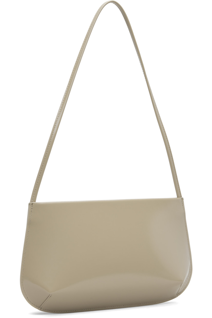 Spazzolato calfskin shoulder bag.

· Fixed shoulder strap
· Darts at base
· Magnetic closure
· Patch pocket at interior
· Twill lining
· H6" x W11" x D2.25"

Supplier color: Latte spazzolato