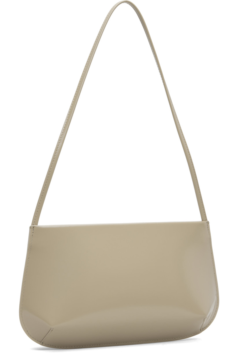 Spazzolato calfskin shoulder bag.

· Fixed shoulder strap
· Darts at base
· Magnetic closure
· Patch pocket at interior
· Twill lining
· H6" x W11" x D2.25"

Supplier color: Latte spazzolato