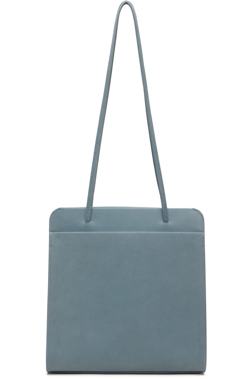 Nubuck shoulder bag.

· Twin shoulder straps
· Patch pocket at back face
· Accordion panel at sides
· Magnetic closure
· Patch pocket at interior
· Twill lining
· H9.75" x W9.25" x D2.75"

Available exclusively at SSENSE.

Supplier color: Blue grey nubuck
