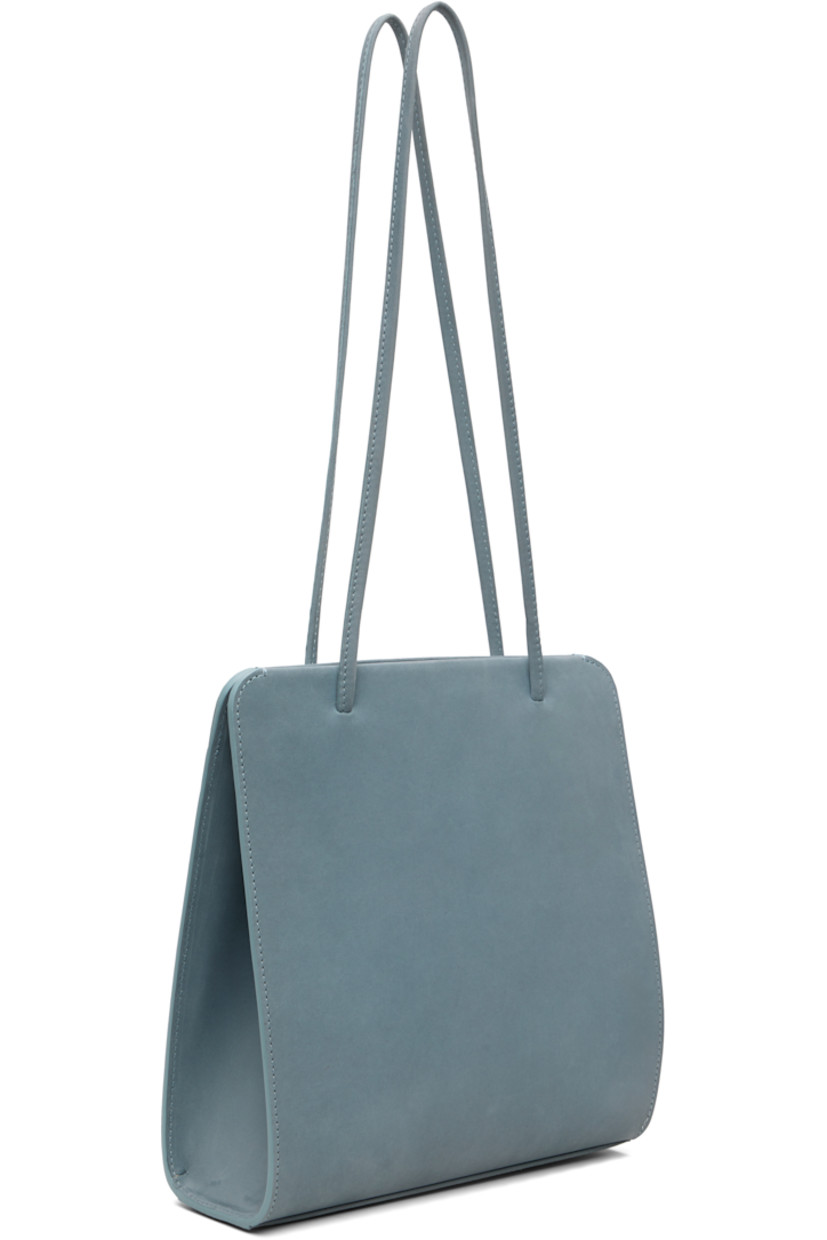 Nubuck shoulder bag.

· Twin shoulder straps
· Patch pocket at back face
· Accordion panel at sides
· Magnetic closure
· Patch pocket at interior
· Twill lining
· H9.75" x W9.25" x D2.75"

Available exclusively at SSENSE.

Supplier color: Blue grey nubuck