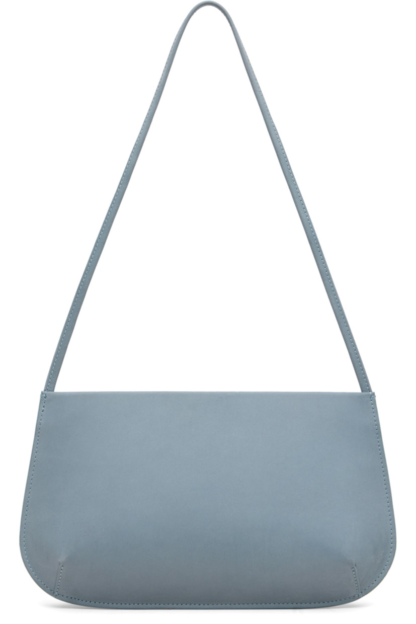 Nubuck shoulder bag.

· Fixed shoulder strap
· Darts at base
· Magnetic closure
· Patch pocket at interior
· Twill lining
· H6" x W11" x D2.25"

Available exclusively at SSENSE.

Supplier color: Blue grey nubuck