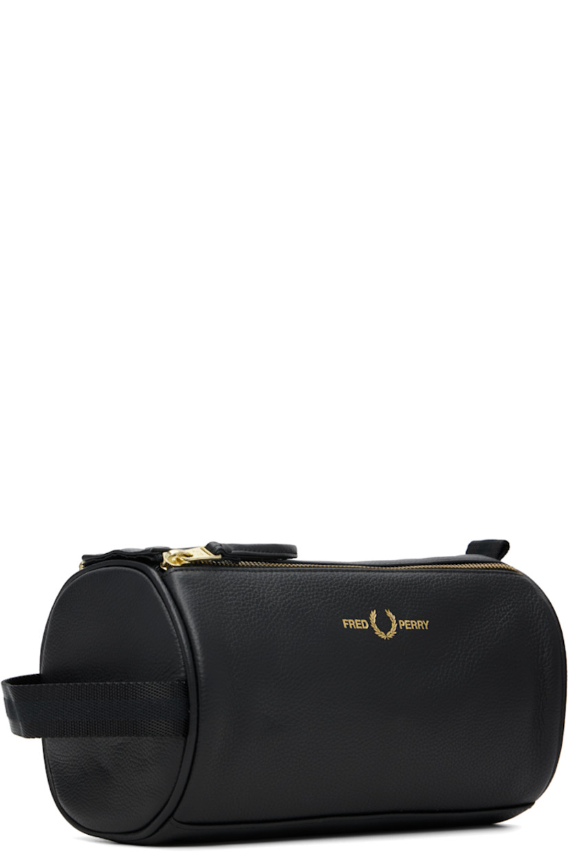 Grained leather toiletry bag.

· Detachable leather strap
· Logo stamp at face
· Pull-loop and webbing strap at sides
· Zip closure with press-stud tab
· Zip pocket at interior
· Logo-printed plain-woven lining
· Logo-engraved gold-tone hardware
· H6.25" x W9" x D5.25"

Supplier color: Black