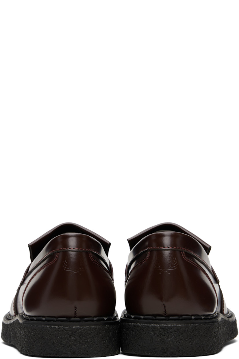 Polished leather loafers.

· Moc toe
· Tassels and fringed trim at vamp
· Logo embossed at heel tab
· Suede lining
· Crêpe-rubber sole

Part of the Fred Perry x George Cox collaboration.

Supplier color: Oxblood