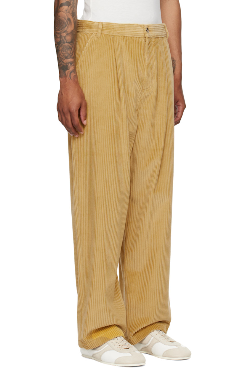 Cotton corduroy trousers.

· Belt loops
· Four-pocket styling
· Zip fly
· Pleats at front
· Logo patch at back waistband

Supplier color: Yellow