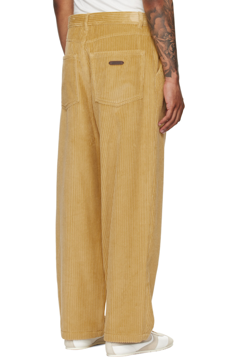 Cotton corduroy trousers.

· Belt loops
· Four-pocket styling
· Zip fly
· Pleats at front
· Logo patch at back waistband

Supplier color: Yellow